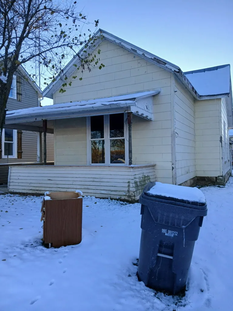 Yellow house before renovation in winter